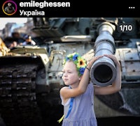 a girl holding a tank in front of a tank